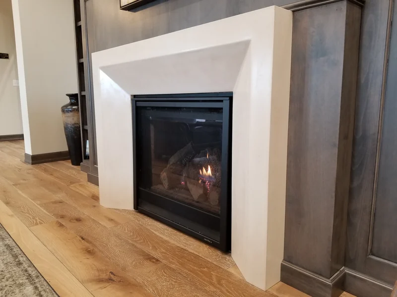 Angular light-colored concrete fireplace surround
